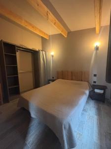 a bedroom with a large bed in a room at A fontanille in Magalas