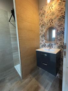 a bathroom with a sink and a mirror at A fontanille in Magalas