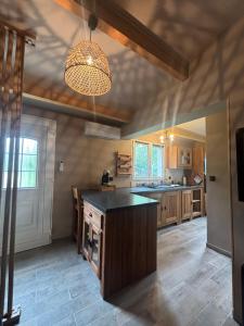a kitchen with a island in the middle of a room at A fontanille in Magalas