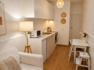 a kitchen with a couch and a table in a room at La Casita de Las Eras in Níjar