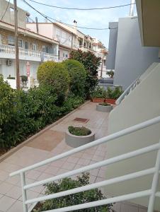 a view from the stairs of a balcony with plants at Casa al'tati studio 27 in Ialysos +11 photos