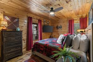 a bedroom with a bed and a ceiling fan at Hearts Hideaway in Morganton