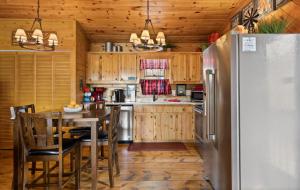 a kitchen with a table and a refrigerator at Hearts Hideaway in Morganton