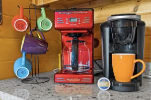 a red mixer sitting on a counter next to a cup at Hearts Hideaway in Morganton