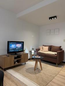a living room with a couch and a flat screen tv at Los Recoletos in Villa Mercedes