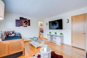 a living room with a couch and a flat screen tv at King Bed • 2BR • Sleeps 13 • Historic Location in Elmwood Park