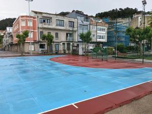 a basketball court in front of some buildings at Casa Bueu Pontevedra in Bueu