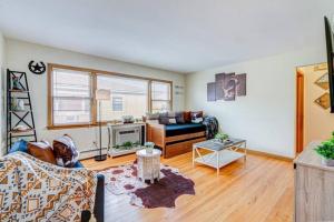 a living room with a couch and a fireplace at King Bed • 2BR • Sleeps 13 • Historic Location in Elmwood Park +5 photos