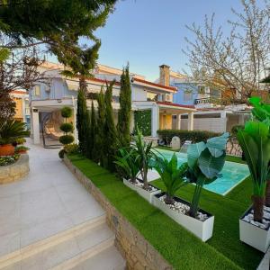 a house with a garden with a swimming pool at villa MEDITERAN in Pefkochori +67 photos