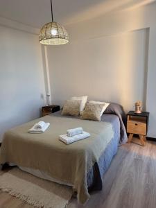 a bedroom with a bed with two towels on it at Los Recoletos in Villa Mercedes