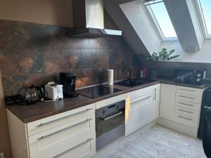 a kitchen with a sink and a stove at Steintor Appartement in Kürten