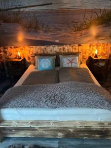 a large bed in a room with lights at Steintor Appartement in Kürten
