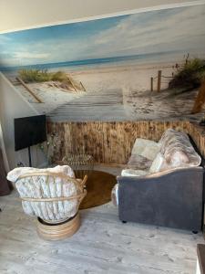a room with a couch and a painting of a beach at Steintor Appartement in Kürten