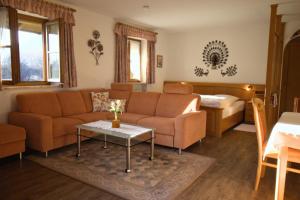a living room with a couch and a table at Kleinreiterhof Ferienwohnungen Limmer in Bad Reichenhall