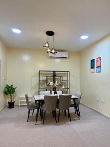 a dining room with a table and chairs at Deluxe Apartment in Muscat