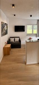 a living room with a couch and a table at ONO Apartments in Längenfeld
