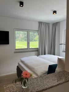 a bedroom with a large bed and a window at ONO Apartments in Längenfeld