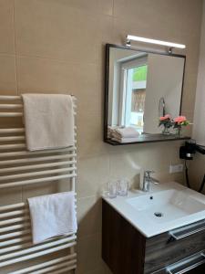 a bathroom with a sink and a mirror at ONO Apartments in Längenfeld +19 photos