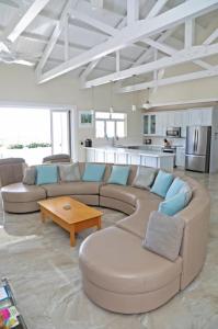 a large living room with a couch and a table at Ocean View Villa with pool in Christ Church