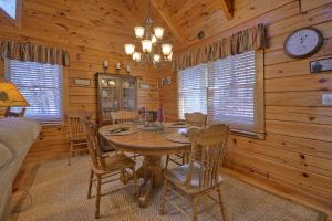 a dining room with a table and chairs in a cabin at Honeys Haven in Morganton +14 photos