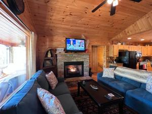 a living room with a couch and a fireplace at Lallybroch in Morganton