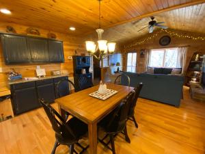 a kitchen and dining room with a wooden table and chairs at Lallybroch in Morganton