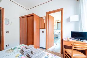 a bedroom with a bed and a desk with towels at Artemisia in Varazze
