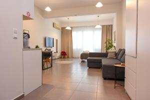 a living room with a couch and a table at Omonoia Central Apartment in Kavála
