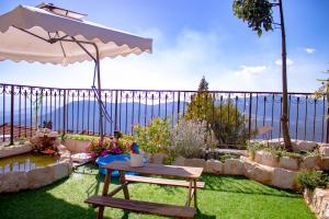 a garden with a table and an umbrella at Sunny's Suite in Safed