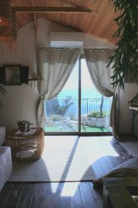 a room with a large glass door with a view at Sunny's Suite in Safed +5 photos