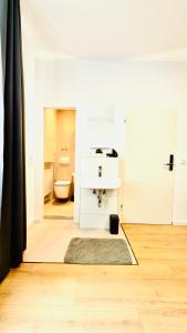 a bathroom with a sink and a toilet at Aparthotel Grünewald in Hannover