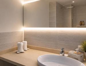 a bathroom with a sink and a mirror at A 2 passi dal mare! in Es Pujols +17 photos