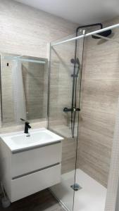 a bathroom with a white sink and a shower at El Chalecito De Alicante in El Campello