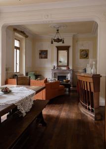 a living room with a table and a fireplace at La Maison Tataouine in Moux