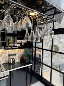 a kitchen with wine glasses hanging from a rack at Kartepe Mountain Villa in Kartepe