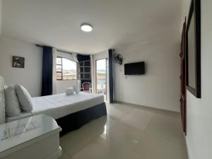 a hotel room with a bed and a television at Hotel Suite Santa Rosa in Santa Rosa de Cabal