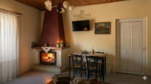 a living room with a table and a fireplace at Thanasis house in Dimitsana
