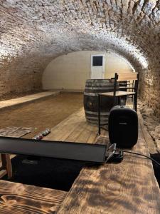 a gym with a treadmill and a table in a tunnel at La Cave Des Merveilles in Mâcon