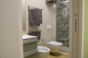 a bathroom with a toilet and a sink and a shower at Open Space Romagna 12 in San Benedetto del Tronto