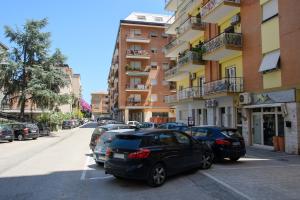 a row of cars parked in front of a building at Open Space Romagna 12 in San Benedetto del Tronto