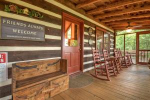 a front porch of a wooden cabin with rocking chairs at Mountain Retreat in Morganton