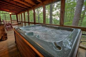 a jacuzzi tub in a cabin in the woods at Mountain Retreat in Morganton