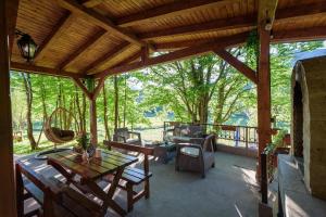 a screened in porch with a table and chairs at Mountain harmony Lovćen in Cetinje +79 photos