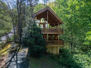 a tree house in the middle of the woods at Bear Hug #18 by Venture Smoky Mountains in Sevierville