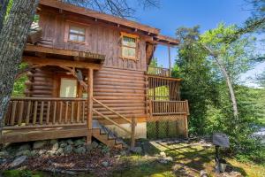 a cabin in the woods with a large deck at Bear Hug #18 by Venture Smoky Mountains in Sevierville +13 photos