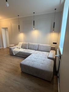 a living room with two couches and a couch at Luxe Lumine Apartment #2 in Kohtla-Järve