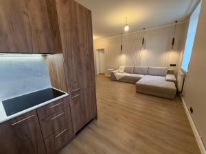 a kitchen and living room with a couch and a sink at Luxe Lumine Apartment #2 in Kohtla-Järve