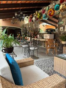a patio with chairs and a table and a table and chairs at Casa de la Abuela in Ajijic