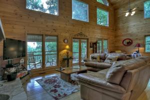 a living room with a couch and a tv in a cabin at My Mountain Paradise in Morganton