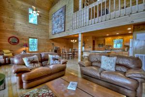 a living room with leather couches and a kitchen at My Mountain Paradise in Morganton
